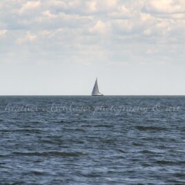 between sea and sky water air sailboat